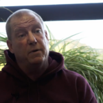 Injured worker Wayne in red sweatshirt