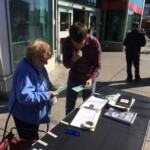 Public signing petition outside Pape subway